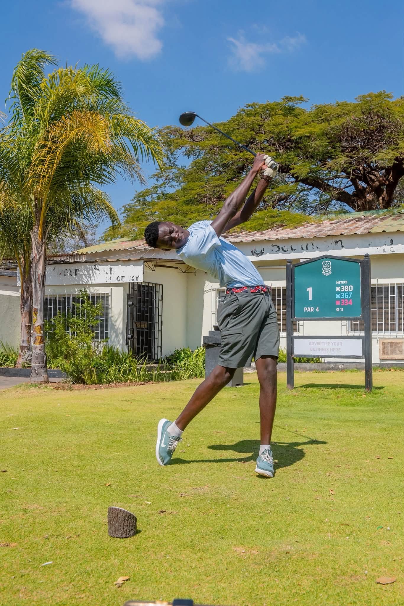 A golfer at the top of his follow-through on the first tee