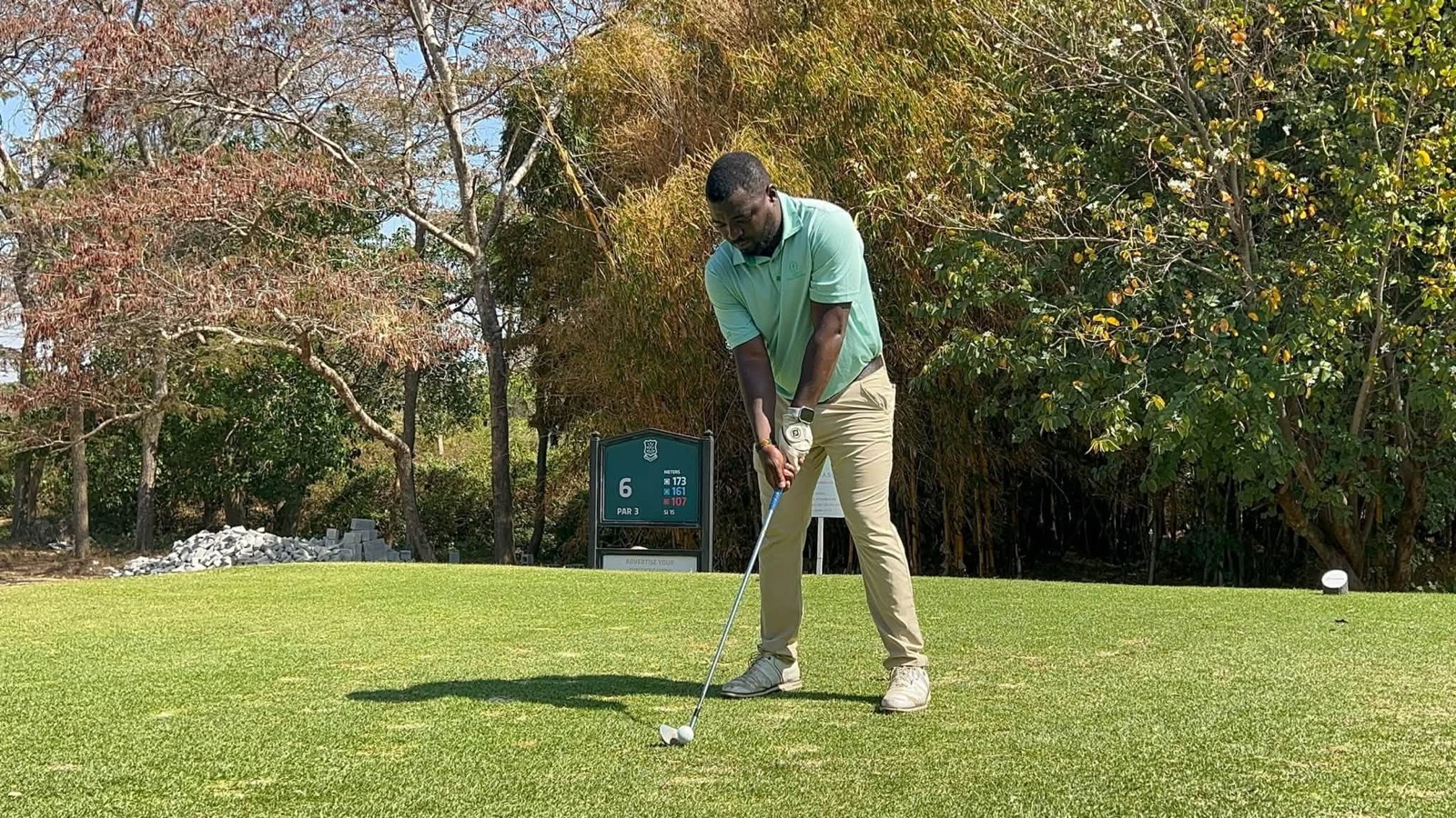 A golfer lines up a tee shot at the sixth on a Sunday round